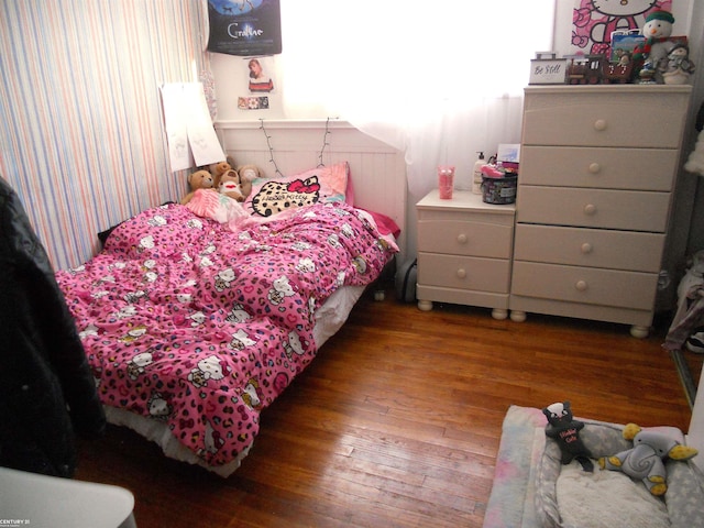 bedroom with wood finished floors