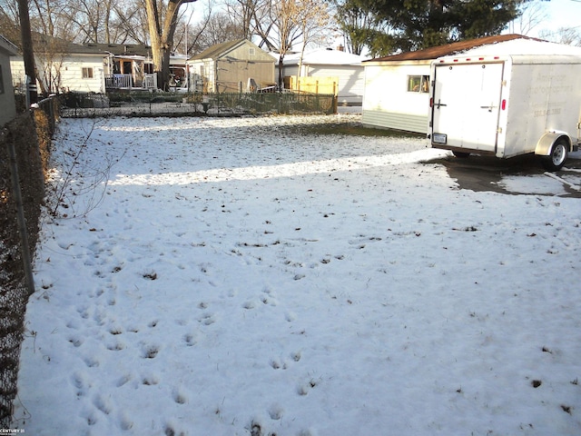 yard layered in snow with fence