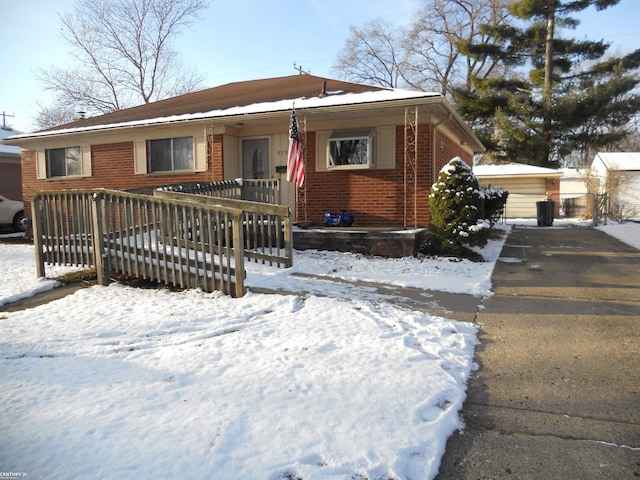 view of front facade with a detached garage and brick siding