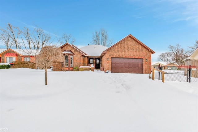 ranch-style house featuring an attached garage, fence, and brick siding