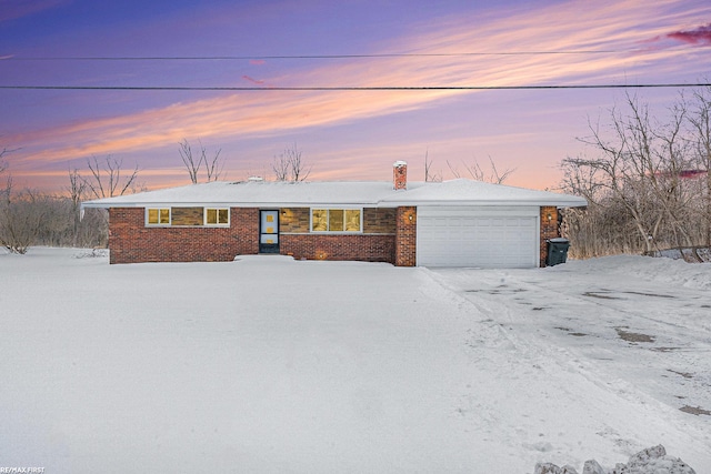 ranch-style house featuring brick siding and an attached garage