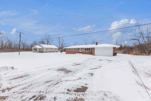 snowy yard featuring an attached garage