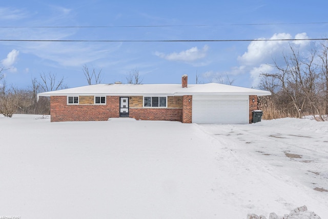 ranch-style home featuring an attached garage and brick siding