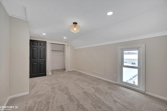 unfurnished bedroom featuring light carpet, vaulted ceiling, recessed lighting, and baseboards