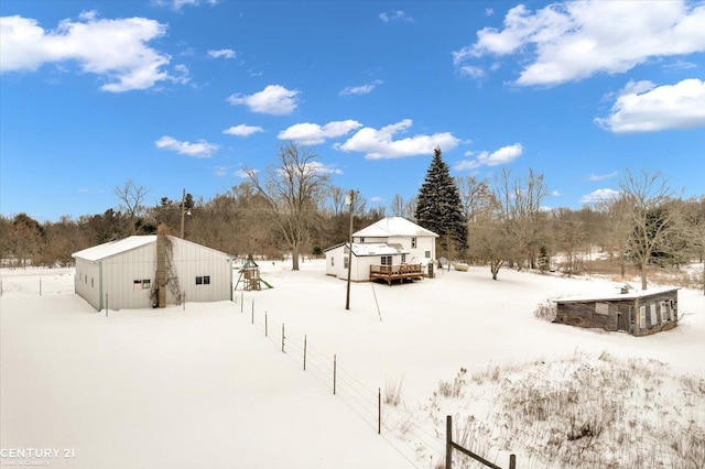 yard covered in snow featuring fence