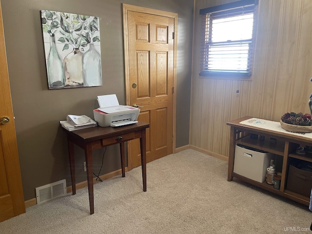 carpeted office space featuring visible vents and baseboards