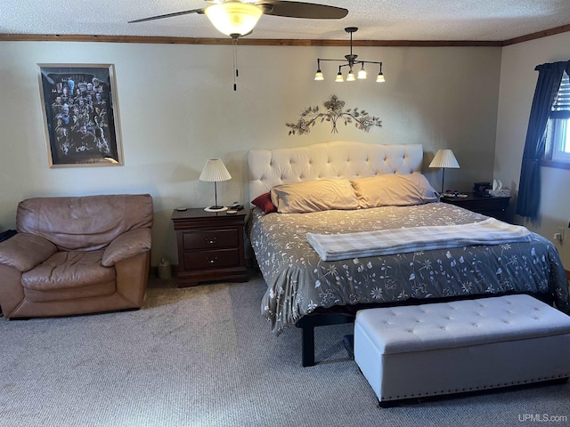 bedroom with a textured ceiling, carpet floors, a ceiling fan, and crown molding