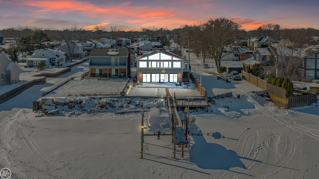 snowy aerial view featuring a residential view