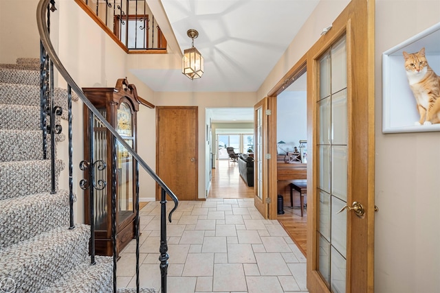 entryway featuring stairway and baseboards