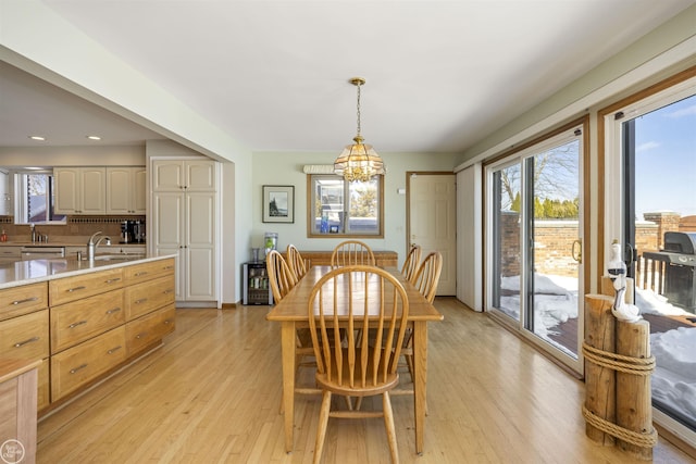 dining room with a chandelier and light wood-style floors