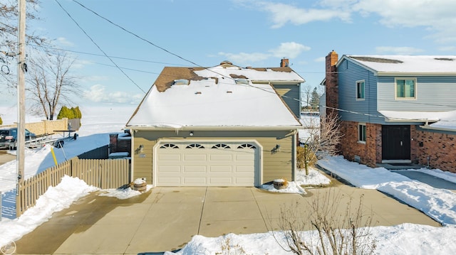 view of front of home featuring a garage and fence