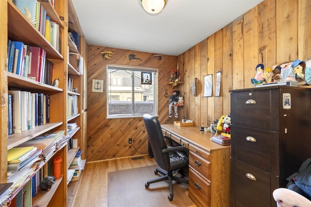 office space featuring wood walls and wood finished floors