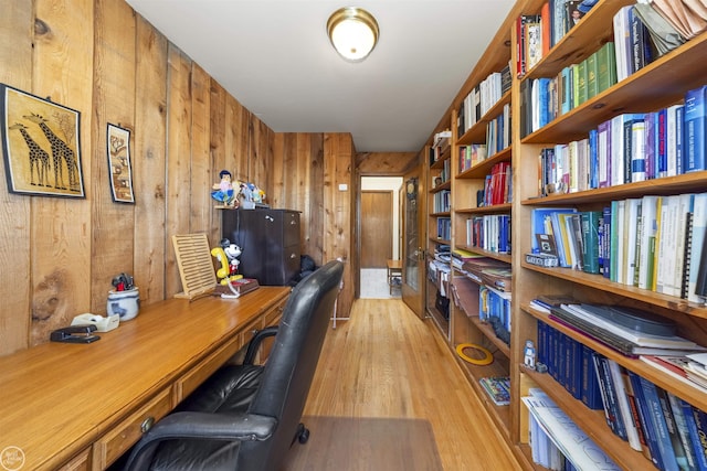 office featuring light wood finished floors and wooden walls