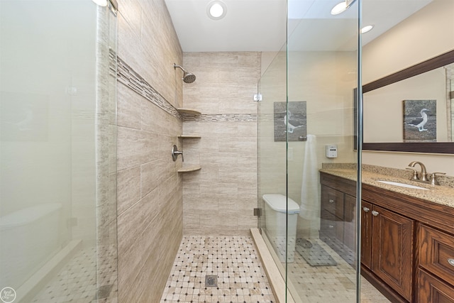 bathroom with a shower stall and vanity