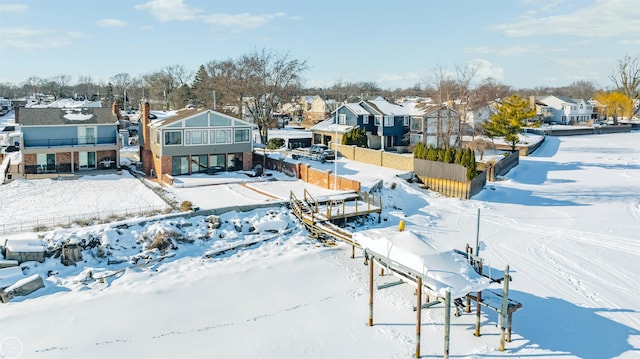 snowy aerial view featuring a residential view