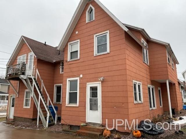 rear view of property with entry steps