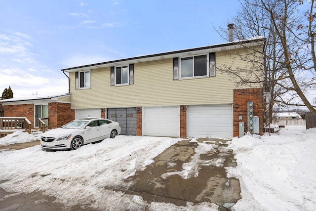 view of front of house with a garage and brick siding