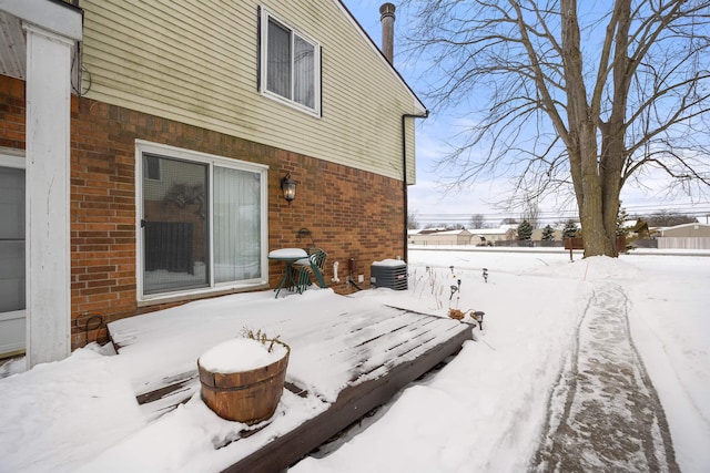 exterior space featuring brick siding and central AC unit