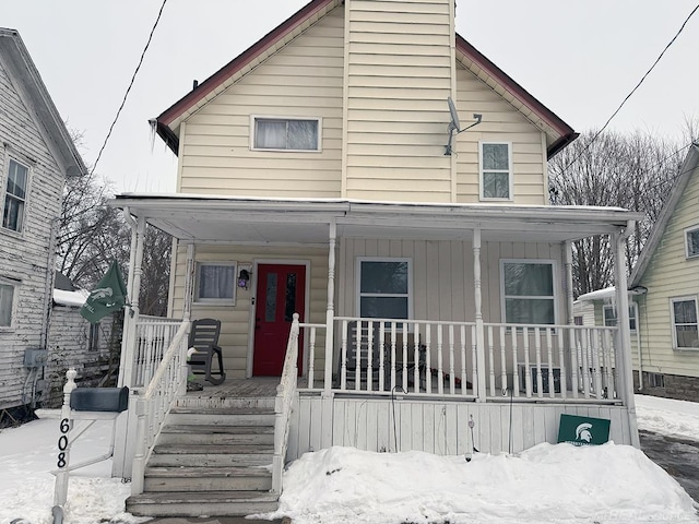 view of front facade with board and batten siding and a porch