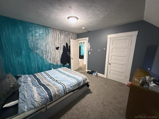 bedroom with a textured ceiling, baseboards, vaulted ceiling, and carpet flooring