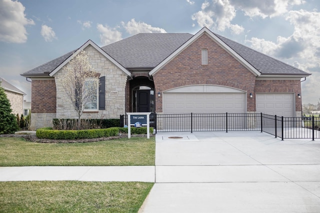 view of front facade with brick siding, roof with shingles, a garage, driveway, and a front lawn