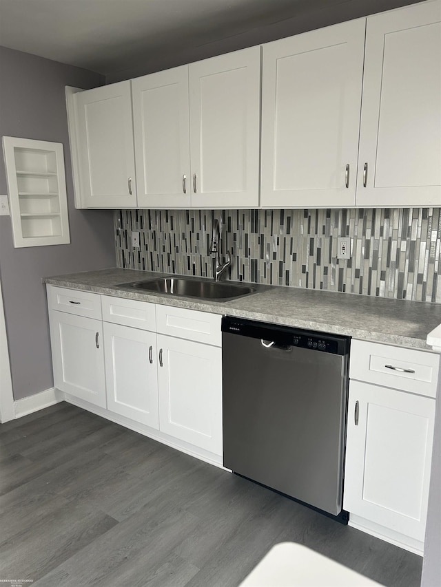 kitchen with tasteful backsplash, white cabinets, dishwasher, light countertops, and a sink