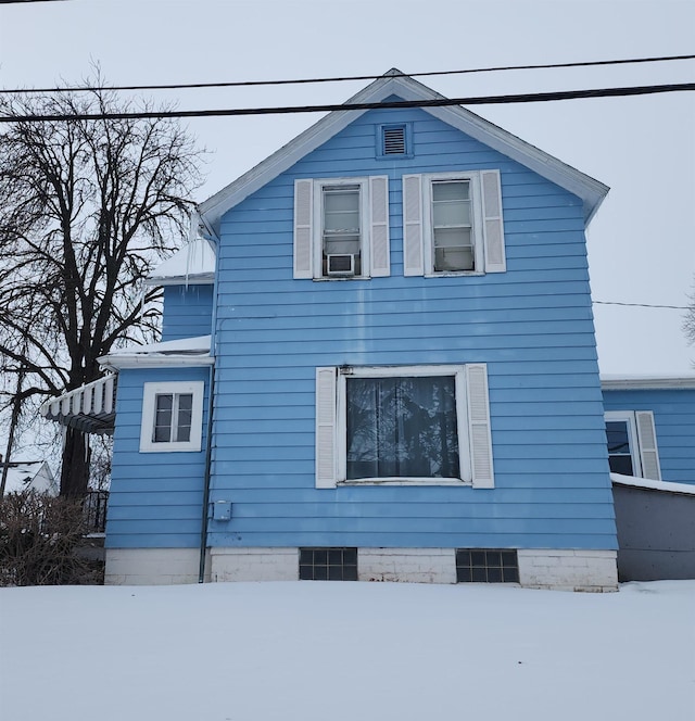 snow covered property with cooling unit