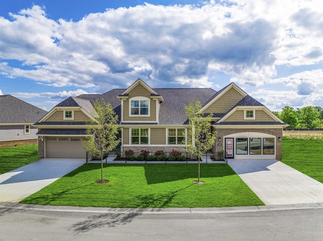 craftsman-style house with a shingled roof, concrete driveway, an attached garage, and a front lawn