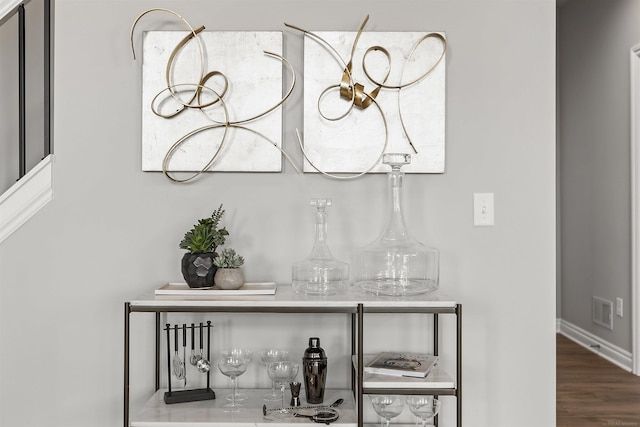 room details featuring visible vents, baseboards, and wood finished floors