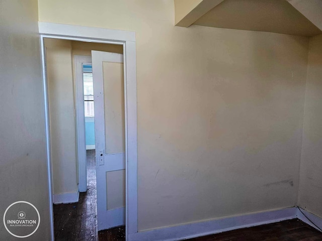 interior space with baseboards and dark wood-type flooring