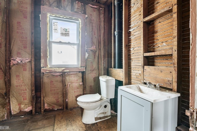 half bathroom featuring vanity and toilet