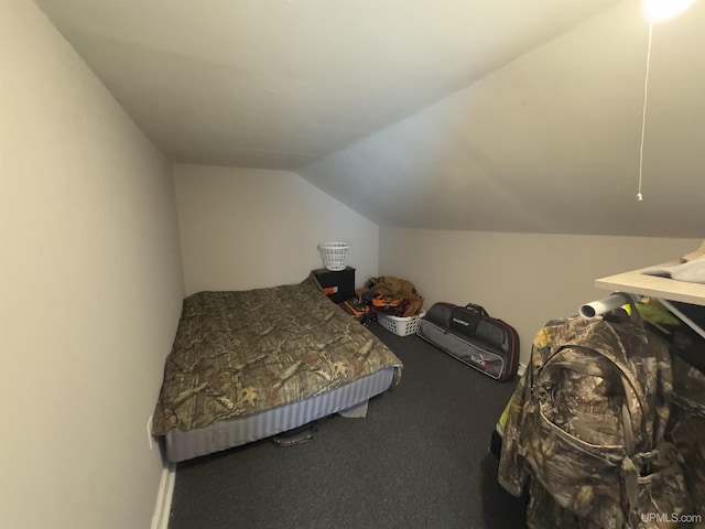 bedroom featuring lofted ceiling and carpet flooring