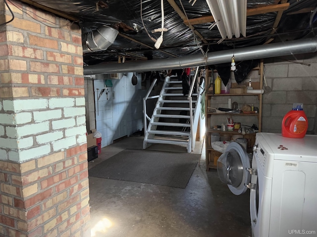 unfinished below grade area with stairs and washer / clothes dryer