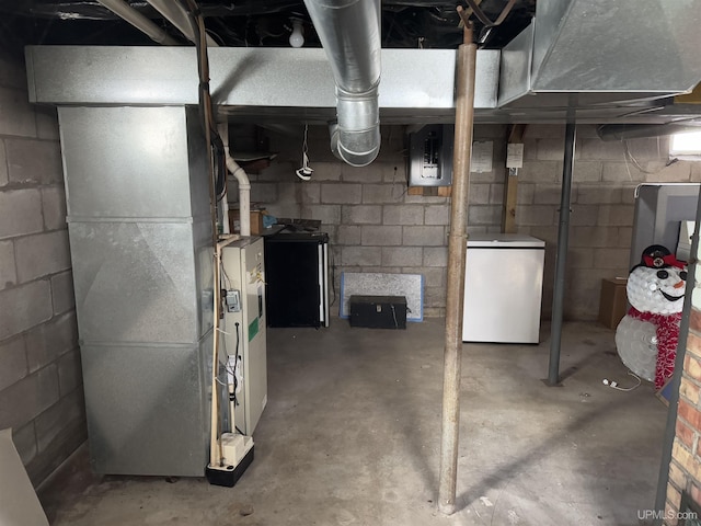 unfinished below grade area with fridge, electric panel, and heating unit