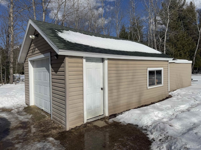 snow covered structure with an outdoor structure