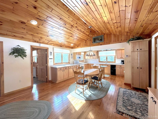 dining room featuring lofted ceiling, wooden ceiling, baseboards, and light wood finished floors