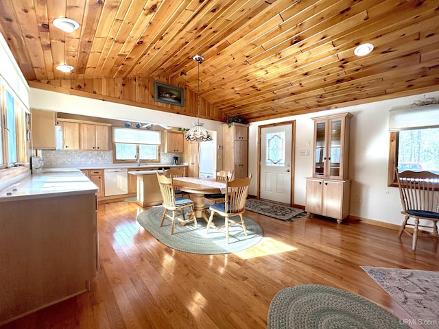 dining room featuring light wood-style floors, wooden ceiling, vaulted ceiling, and baseboards