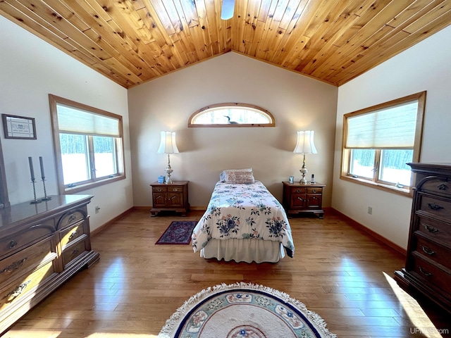 bedroom featuring wooden ceiling, vaulted ceiling, baseboards, and wood finished floors