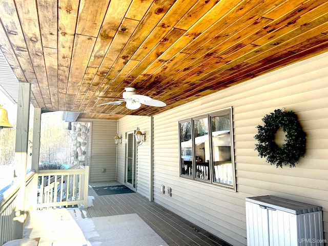 wooden terrace featuring a ceiling fan