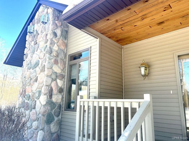 entrance to property featuring stone siding