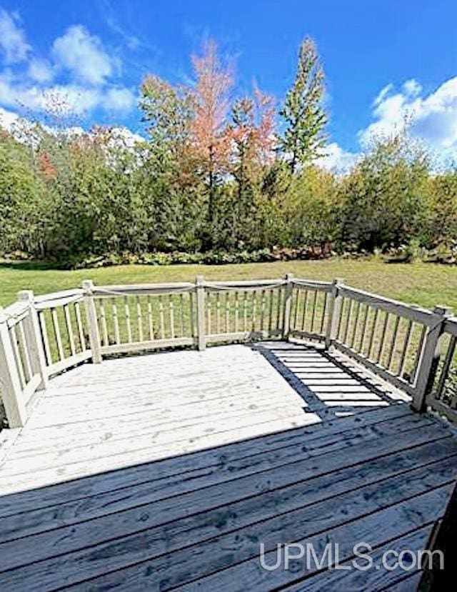 wooden terrace featuring a yard