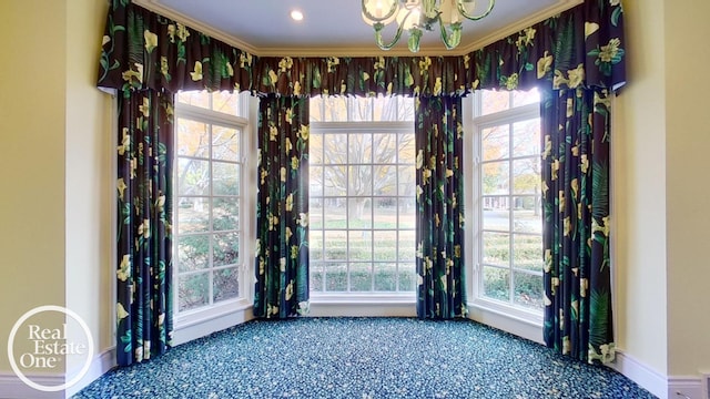 interior space featuring carpet floors, a wealth of natural light, crown molding, and baseboards