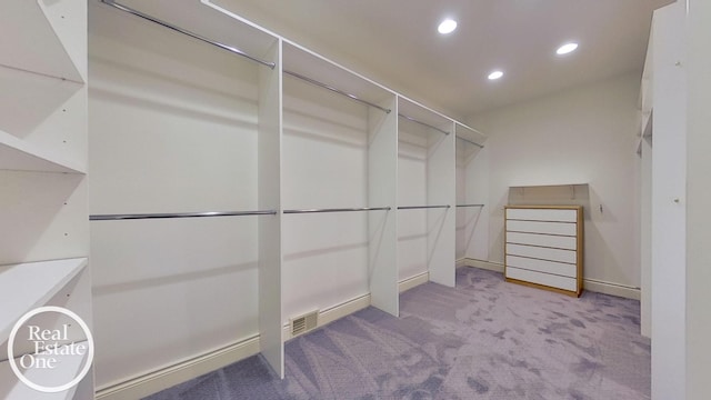 spacious closet featuring light carpet and visible vents