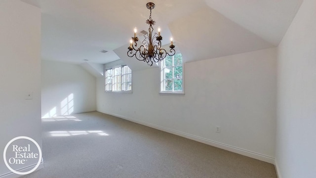 bonus room with vaulted ceiling, carpet, a chandelier, and baseboards