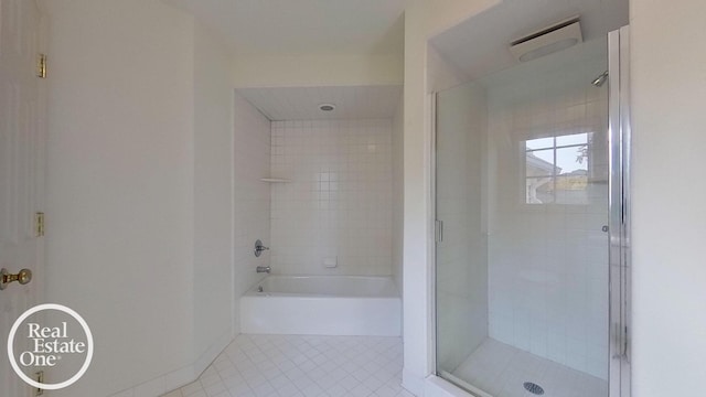 bathroom featuring tile patterned flooring, a shower stall, a bath, and baseboards