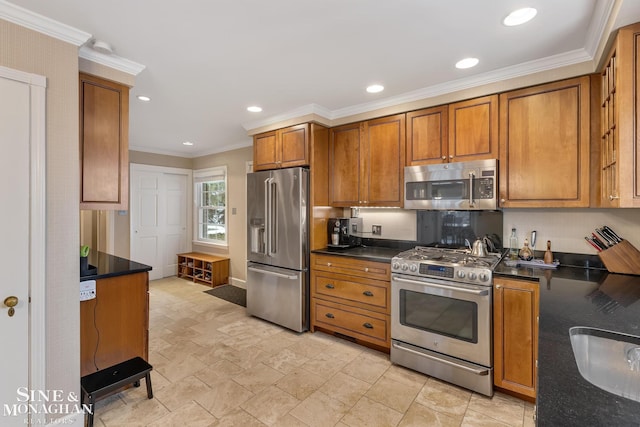 kitchen featuring dark countertops, appliances with stainless steel finishes, brown cabinets, and ornamental molding