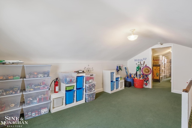 playroom with lofted ceiling, dark colored carpet, and baseboards