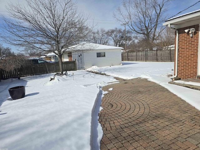 snowy yard featuring fence