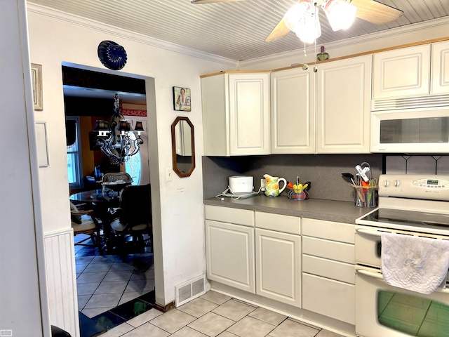 kitchen featuring light tile patterned floors, white appliances, visible vents, dark countertops, and crown molding