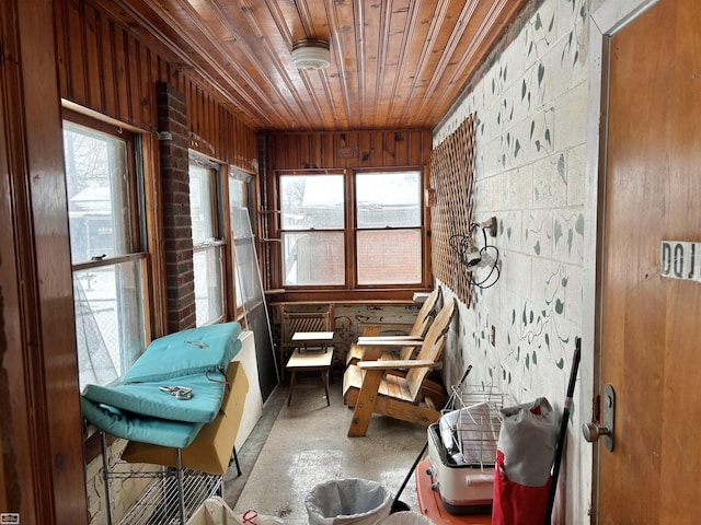 sunroom featuring wooden ceiling and a wealth of natural light